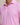 Close-up of a pink patterned polo shirt on a neutral background